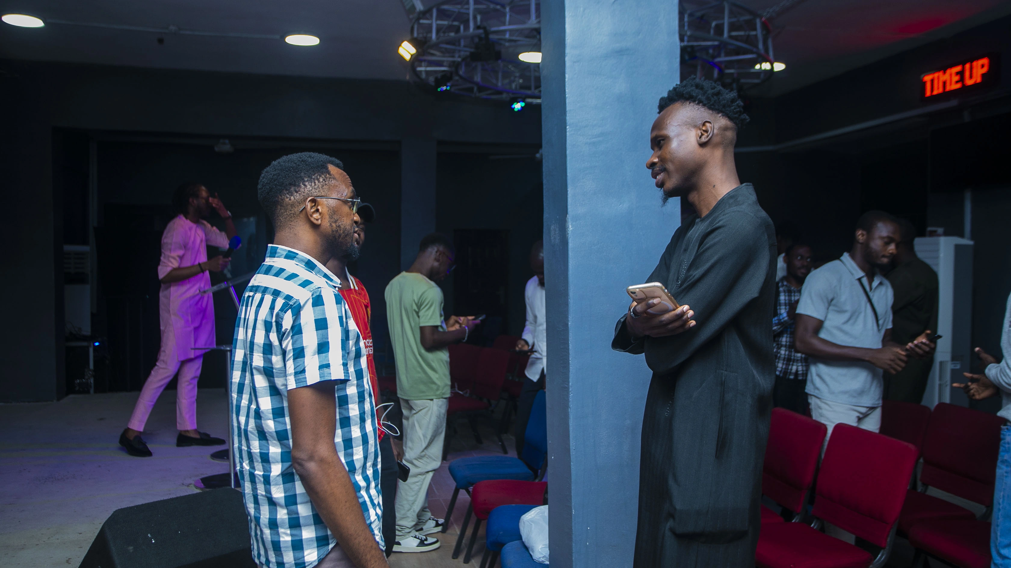 Two men standing face to face in conversation